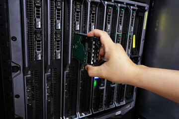 Hand Removing Hard Drive from Server Rack Unit