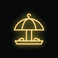 Fototapeta premium Neon yellow glowing icon of a bird feeder with an umbrella on a black background