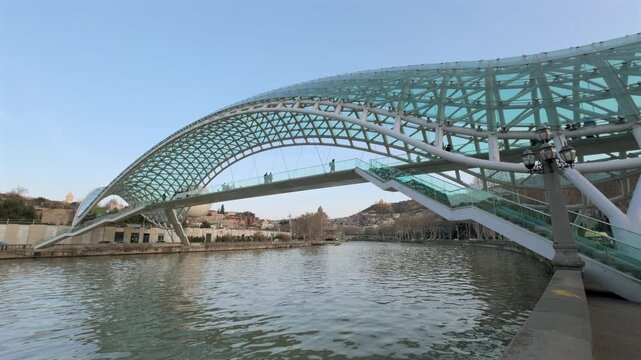 sunset time tbilisi city center famous glass walking bridge riverside traffic panorama 4k georgia