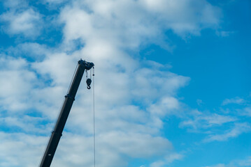Fototapeta premium Construction Crane with Blue Sky and Clouds