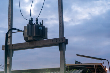 Obraz premium Electrical Transformer against Cloudy Sky