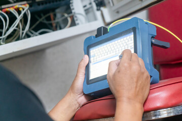 Technician Using Handheld Device for Data Entry