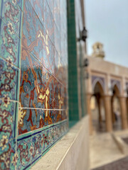 Vibrant Islamic Tile Mosaic with Mosque Arches in Background. Qatar