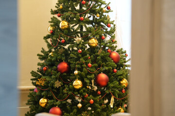 Christmas tree adorned with colorful ornaments and festive decorations, creating a warm holiday atmosphere, perfect for seasonal celebrations and joyful gatherings