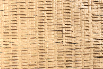 Shredded cardboard creates an abstract corrugated texture for sustainable packaging