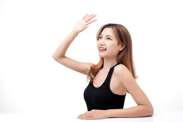 Beautiful young Asian woman with natural makeup and healthy glowing skin smiling confidently on white background