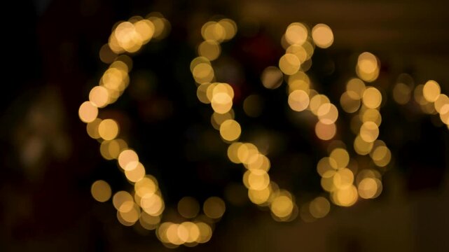 Abstract bokeh background with soft focus, glowing golden lights on Christmas tree
