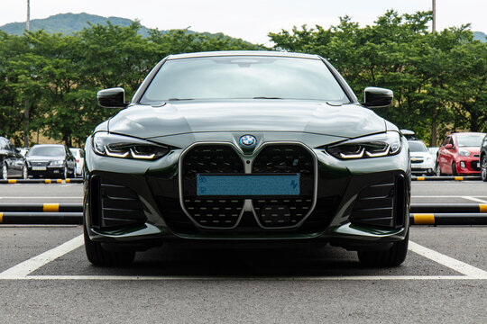 June 5, 2022, Seoul, South Korea - A front view of a dark green BMW i4 electric vehicle parked in a parking lot.