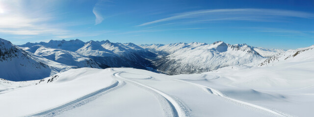 Panoramic view down snow covered valley in alpine mountain range 
