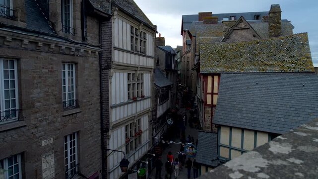 Mont-Saint-Michel, Normandy, 08-24-2024. Medieval houses within the walls of Mont Saint Michel. Panning 4K