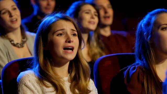 Female Choir Members Singing Emotionally in a Performance Setting