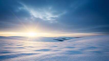Sunrise over snowy hills with a blue sky and soft clouds in winter landscape