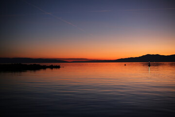 sunset over the sea with a view of the mountains