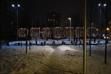 Christmas decoration on the streets in snow at night