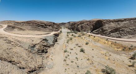 This high-quality drone photograph presents a sweeping aerial round flight over the dramatic landscapes of Namibia, offering a breathtaking bird’s-eye view of one of the world’s oldest deserts.