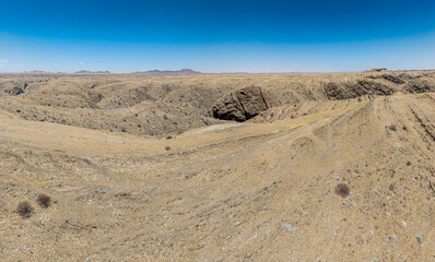 This high-quality drone photograph presents a sweeping aerial round flight over the dramatic landscapes of Namibia, offering a breathtaking bird&rsquo;s-eye view of one of the world&rsquo;s oldest deserts. The ca
