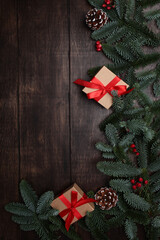 Spruce branches and cones on wooden background. Christmas ornament. Background for New Year's cards.Copy space. Flat lay.