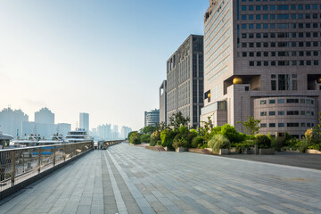 Modern Urban Promenade with Tall Buildings Under Clear Sky
