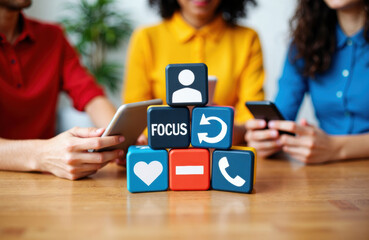 Team using smartphones with social media icon blocks stacked to symbolize focus