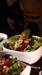 Fresh Green Salad with Cherry Tomatoes Served in White Bowl