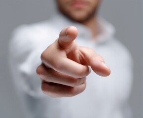 Male hand pointing directly at the camera on a neutral background, symbolizing attention, choice, direction, invitation, leadership, and direct communication in a modern minimalist style.