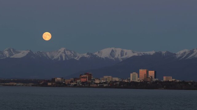 Full moon over Anchorage skyline