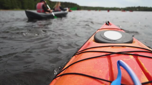 Kayaking in the lake skerries, colorful canoe kayak boat paddling, canoeing in river, scandinavian landscape, group of tourists athletes in kayaks floating, kayakers rowing during water sports tour