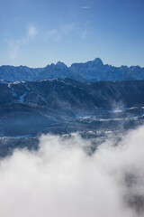 Beauty of the winter Alps seen through rising fog, Austria, with mesmerizing mountain peaks