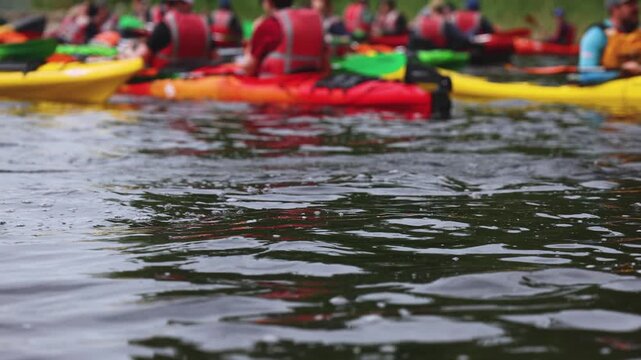 Kayaking in the lake skerries, colorful canoe kayak boat paddling, canoeing in river, scandinavian landscape, group of tourists athletes in kayaks floating, kayakers rowing during water sports tour
