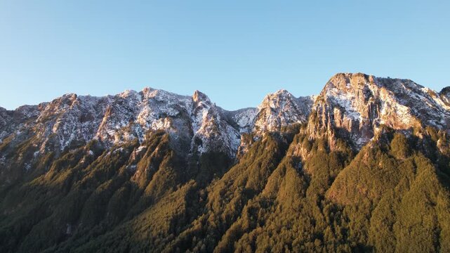 Aerial shot of a mountain cliff and snow