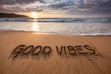 Good Vibes Evenly Spaced in Clean Sand with Smooth Tidy Strokes, Wet Shine and Approaching Tide at Golden Hour &ndash; ideal for inspirational prints