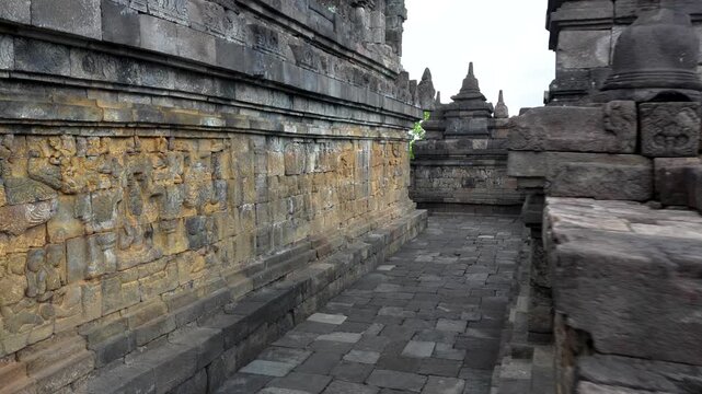 Walking around the Buddist temple Borobudur near Yogyakarta city, Central Java, Indonesia. World famous landmark in Indonesia