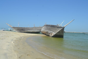 Fototapeta premium An old, broken boat looks out to sea. Hope slowly dies with it. Foggy future. 