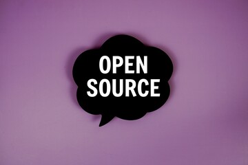 Open Source text with speech bubble top view on purple background