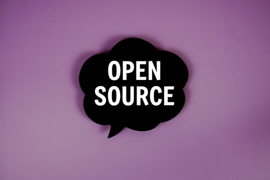 Open Source text with speech bubble top view on purple background