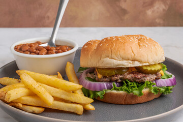 smashburger  with bake beans and a side of french fries