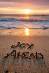 Fototapeta premium Joy Ahead Tidy Natural Handwriting in Sand with Meticulously Shaped Letters and Bright Golden Sun at Horizon – perfect for motivational prints