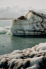 Detailed view of icebergs floating in Jokulsarlon Glacier Lagoon, Iceland. Close-up textures of melting ice and volcanic ash layers reveal the beauty and fragility of Arctic nature and climate change 