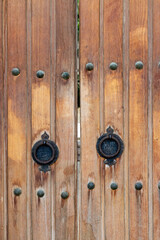 Fototapeta premium Wooden door with metal handles on a mosque in Baku