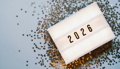 Modern 2026 LED Display Background: Glowing Light Box, Silver Star Confetti, and Clean Copy Space