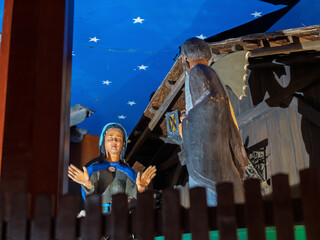 Intricate Wooden Religious Figurines Beneath Starry Ceiling