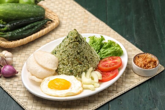Nasi goreng cabe hijau. Green fried rice is a Indonesian fried rice that is green in color because it uses green chilies its main seasoning.