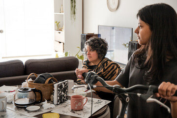 A woman is sitting at a table with a mug and a bicycle