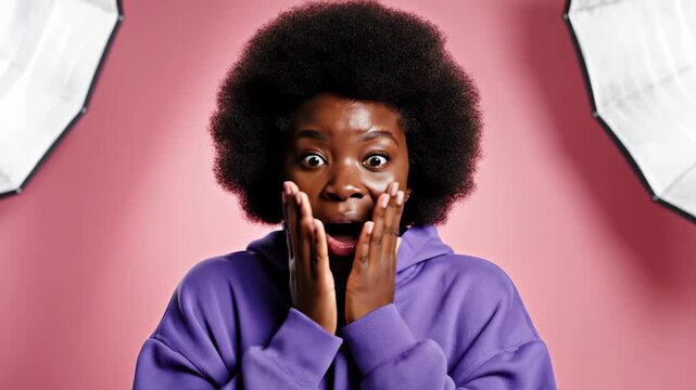 Young Black Woman Expresses Shock and Surprise with Wide Eyes and Open Mouth.