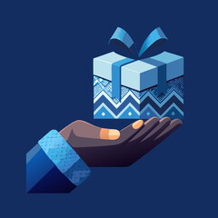 Hand holding a festive gift box with blue ribbon and patterned wrapping concept of giving and celebration isolated on a dark blue background