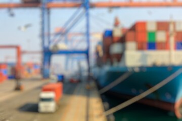 Obraz premium Blurred Background of Dynamic Container Port Operations During the day. Blurry Background For Design Projects.