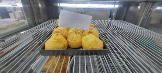 Brazilian cheese bread in a bakery shop, closeup of photo.