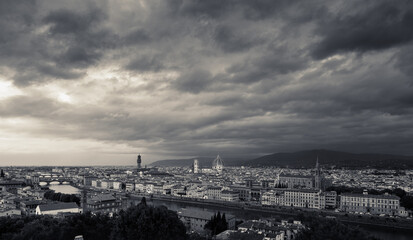 Dramatic storm clouds over a timeless river city skyline in moody weather with cathedral dome and historic bridges fine art travel photography capturing melancholy grandeur and quiet hope today