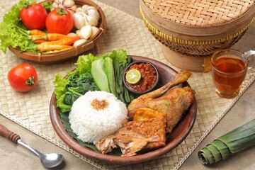 Sego tempong or nasi tempong is a traditional Banyuwangi dish served with various side dishes, fresh vegetables, and special chili sauce