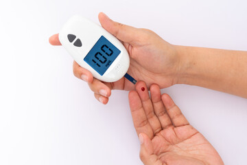 Woman's hands checking diabetes and hyperglycemia with digital blood sugar meter. Healthcare and medical concept	